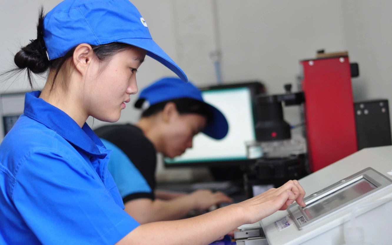 Workers inspecting product details in a quality control process